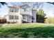 Lush backyard featuring a well-maintained lawn, mature trees, and an outdoor seating area at 17020 W 64Th Dr, Arvada, CO 80007