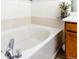 Bathroom featuring a soaking tub with tile surround and chrome fixtures at 17020 W 64Th Dr, Arvada, CO 80007