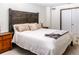 Bedroom featuring a wood headboard, bedside tables, and cozy bedding at 17020 W 64Th Dr, Arvada, CO 80007