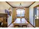 Cozy dining room featuring a chandelier, wooden table, and ample natural light from the window at 17020 W 64Th Dr, Arvada, CO 80007