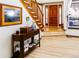 Inviting foyer with hardwood floors, staircase, and natural light from the sidelight windows at 17020 W 64Th Dr, Arvada, CO 80007