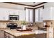 Modern kitchen featuring stainless steel appliances, white cabinets, and a center island with granite countertops at 17020 W 64Th Dr, Arvada, CO 80007