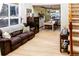 Spacious living area open to dining room, featuring hardwood floors and ample natural light at 17020 W 64Th Dr, Arvada, CO 80007