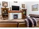 Cozy living room featuring a fireplace with marble tile and built-in bookshelves at 17020 W 64Th Dr, Arvada, CO 80007