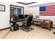 Well-appointed home office space with large monitors, comfortable seating, and ample natural light at 17020 W 64Th Dr, Arvada, CO 80007