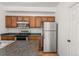 Efficient kitchen with stainless steel appliances, wood cabinetry, and plenty of counter space at 1771 W 53Rd Pl # 1, Denver, CO 80221