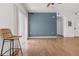 Spacious living room featuring hardwood floors, a blue accent wall, and an open layout at 1771 W 53Rd Pl # 1, Denver, CO 80221