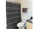 Bathroom featuring a toilet, patterned shower curtain, and neutral-colored towels on a towel rack at 500 30Th St # 5, Denver, CO 80205