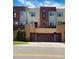 Modern townhome with a brick and stucco exterior, garage, and well-maintained landscaping at 500 30Th St # 5, Denver, CO 80205