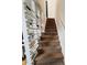Carpeted staircase ascends with a custom slat-style divider adding a modern touch to the interior at 500 30Th St # 5, Denver, CO 80205