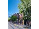 Street view of local shops with trees, signage, and brick architecture at 500 30Th St # 5, Denver, CO 80205