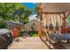 Back deck featuring wood floors, dining set and grill in a backyard with grass and detached garage at 2829 N Franklin St, Denver, CO 80205