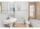 Bathroom with modern vanity, updated toilet, and convenient in-unit washer and dryer at 2829 N Franklin St, Denver, CO 80205