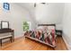Bright bedroom with hardwood floors, a stained-glass window, and classic vintage touches at 2829 N Franklin St, Denver, CO 80205