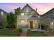 Charming two-story home with a well-manicured front yard and cozy front porch seating area at 2829 N Franklin St, Denver, CO 80205