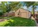 Detached garage with a tan exterior, landscaping, and a stone pathway in the backyard at 2829 N Franklin St, Denver, CO 80205