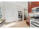 Spacious kitchen with stainless steel appliances, granite countertops, and access to the living area at 2829 N Franklin St, Denver, CO 80205