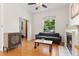 Bright living room featuring hardwood floors, fireplace, and a modern sofa with natural light at 2829 N Franklin St, Denver, CO 80205