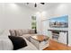 Comfortable living room with hardwood floors, a large sectional, and a modern entertainment center at 2829 N Franklin St, Denver, CO 80205