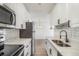 Modern kitchen features white cabinets, stainless steel appliances, and quartz countertops at 7755 E Quincy Ave # 301A2, Denver, CO 80237