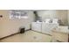 Laundry room with several washing machines and a service sink at 7755 E Quincy Ave # 301A2, Denver, CO 80237