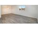 A large living space features an adjacent window and new flooring at 7755 E Quincy Ave # 301A2, Denver, CO 80237