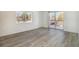 A spacious bright living room with new flooring and a sliding glass door to the balcony at 7755 E Quincy Ave # 301A2, Denver, CO 80237