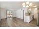 Bright living room features updated flooring, a sliding glass door and access to the kitchen at 7755 E Quincy Ave # 301A2, Denver, CO 80237