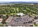 Aerial view of a golf community featuring tennis courts, a pool, a clubhouse and a parking lot at 3860 S Elkhart St, Aurora, CO 80014