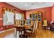 Formal dining room featuring an elegant wood table, china cabinet and lovely natural light at 3860 S Elkhart St, Aurora, CO 80014