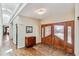 Inviting foyer with hardwood floors, skylights, and beautiful wood door with decorative glass panels at 3860 S Elkhart St, Aurora, CO 80014