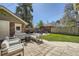 A cozy backyard featuring a deck, a fire pit, and a patio at 2836 Cherry St, Denver, CO 80207