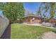 View of backyard featuring a lush lawn, patio and charming brick building at 2836 Cherry St, Denver, CO 80207