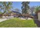 The backyard features a patio, a fire pit, a deck, and green grass at 2836 Cherry St, Denver, CO 80207