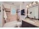 Bathroom showcasing decorative tile work, a vanity, and a bathtub with shower at 2836 Cherry St, Denver, CO 80207