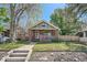 Charming brick bungalow with a welcoming front porch and well-maintained lawn at 2836 Cherry St, Denver, CO 80207