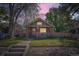 Charming brick bungalow with a welcoming front porch and well-maintained lawn at 2836 Cherry St, Denver, CO 80207