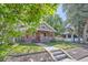 Charming brick bungalow with a welcoming front porch and well-maintained lawn at 2836 Cherry St, Denver, CO 80207
