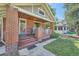 Charming brick bungalow with a welcoming front porch and well-maintained lawn at 2836 Cherry St, Denver, CO 80207