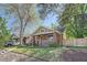 Charming brick bungalow with a welcoming front porch and well-maintained lawn at 2836 Cherry St, Denver, CO 80207