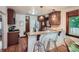 Kitchen featuring wooden cabinetry, granite countertops, stainless steel appliances, and barstool seating at 2836 Cherry St, Denver, CO 80207