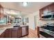 Open concept kitchen showcasing stainless steel appliances, granite countertops, and seamless access to the living space at 2836 Cherry St, Denver, CO 80207