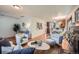 Bright living room featuring hardwood floors, white walls, stylish decor, and an open layout to the kitchen at 2836 Cherry St, Denver, CO 80207