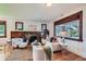 Bright living room with a stone fireplace, hardwood floors, and large windows at 2836 Cherry St, Denver, CO 80207