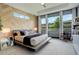 Bright bedroom featuring a wood accent wall, large windows, and plush carpeting at 3436 W 154Th Ave, Broomfield, CO 80023