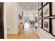 Hallway with hardwood flooring, decorative wall art, and natural light flowing into an open-concept layout at 3436 W 154Th Ave, Broomfield, CO 80023