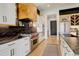 Gourmet kitchen boasts stainless steel appliances, custom hood, and beautiful countertops at 3436 W 154Th Ave, Broomfield, CO 80023