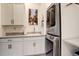 Well-equipped laundry room with stacked washer/dryer and ample cabinets at 3436 W 154Th Ave, Broomfield, CO 80023