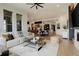 Open-concept living space with a modern fireplace, hardwood floors, and abundant natural light throughout at 3436 W 154Th Ave, Broomfield, CO 80023