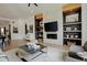 Comfortable living room featuring a fireplace, custom shelving, and stylish decor with great natural light at 3436 W 154Th Ave, Broomfield, CO 80023